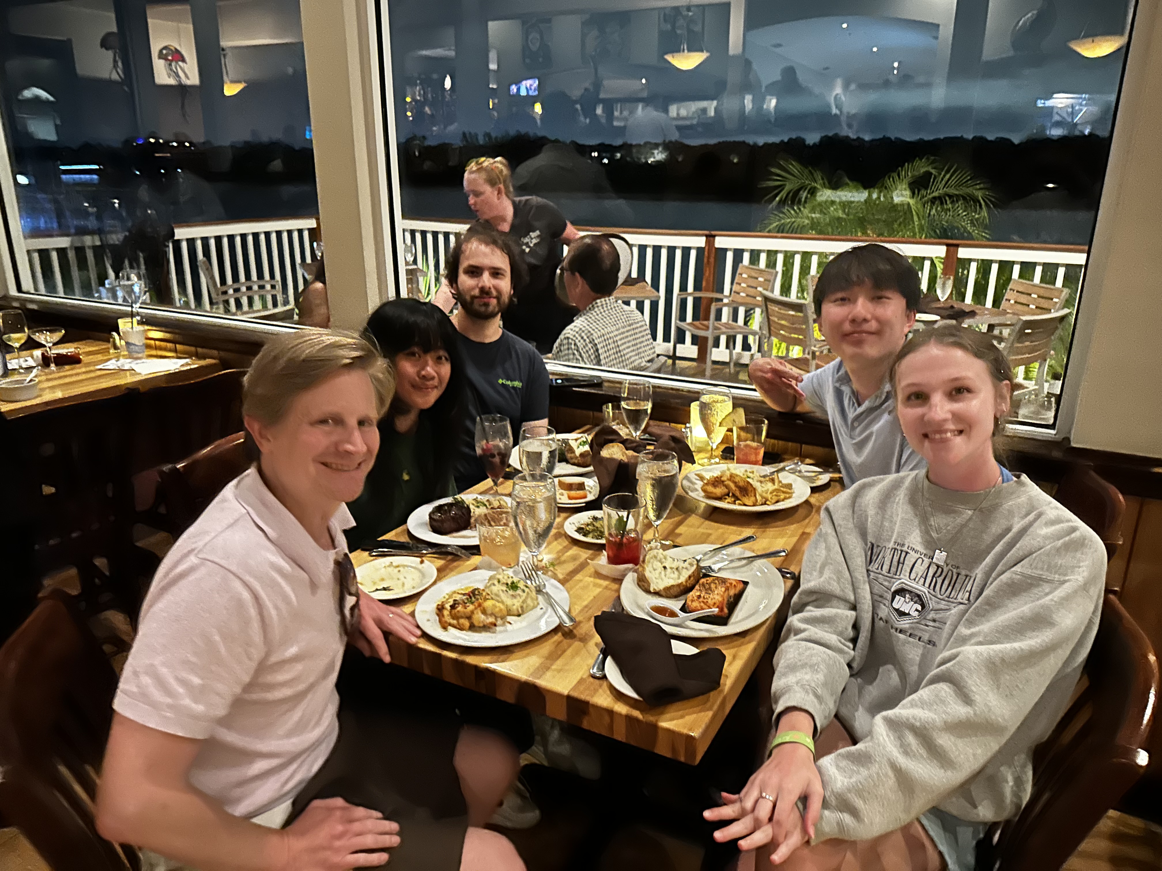 Haberman Lab members celebrating over dinner during VSS 2026